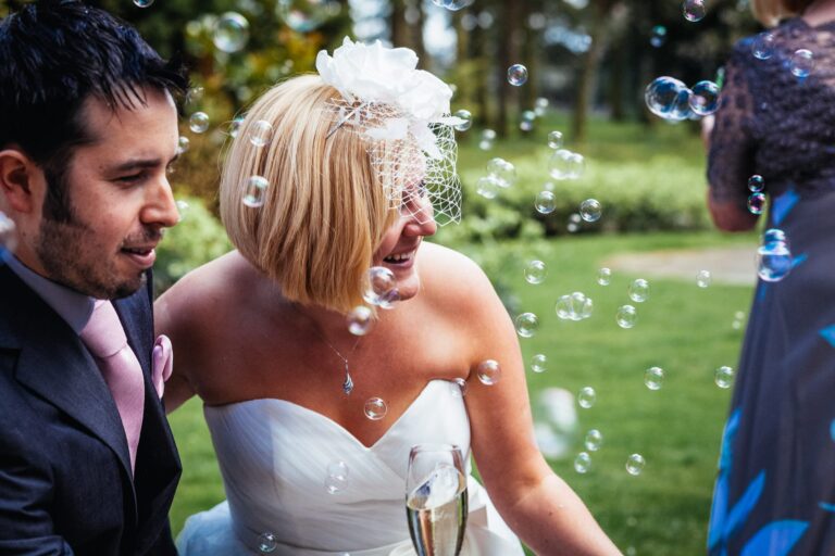 bride and groom with bubbles at great hallingbury manor wedding