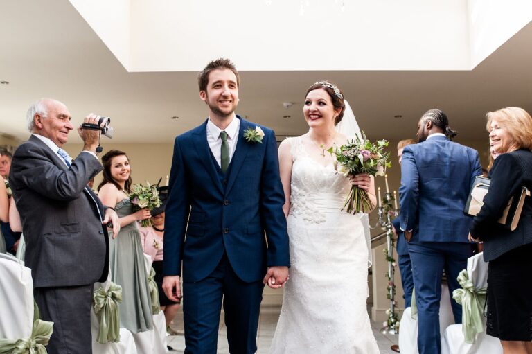 walking down the aisle together newlyweds