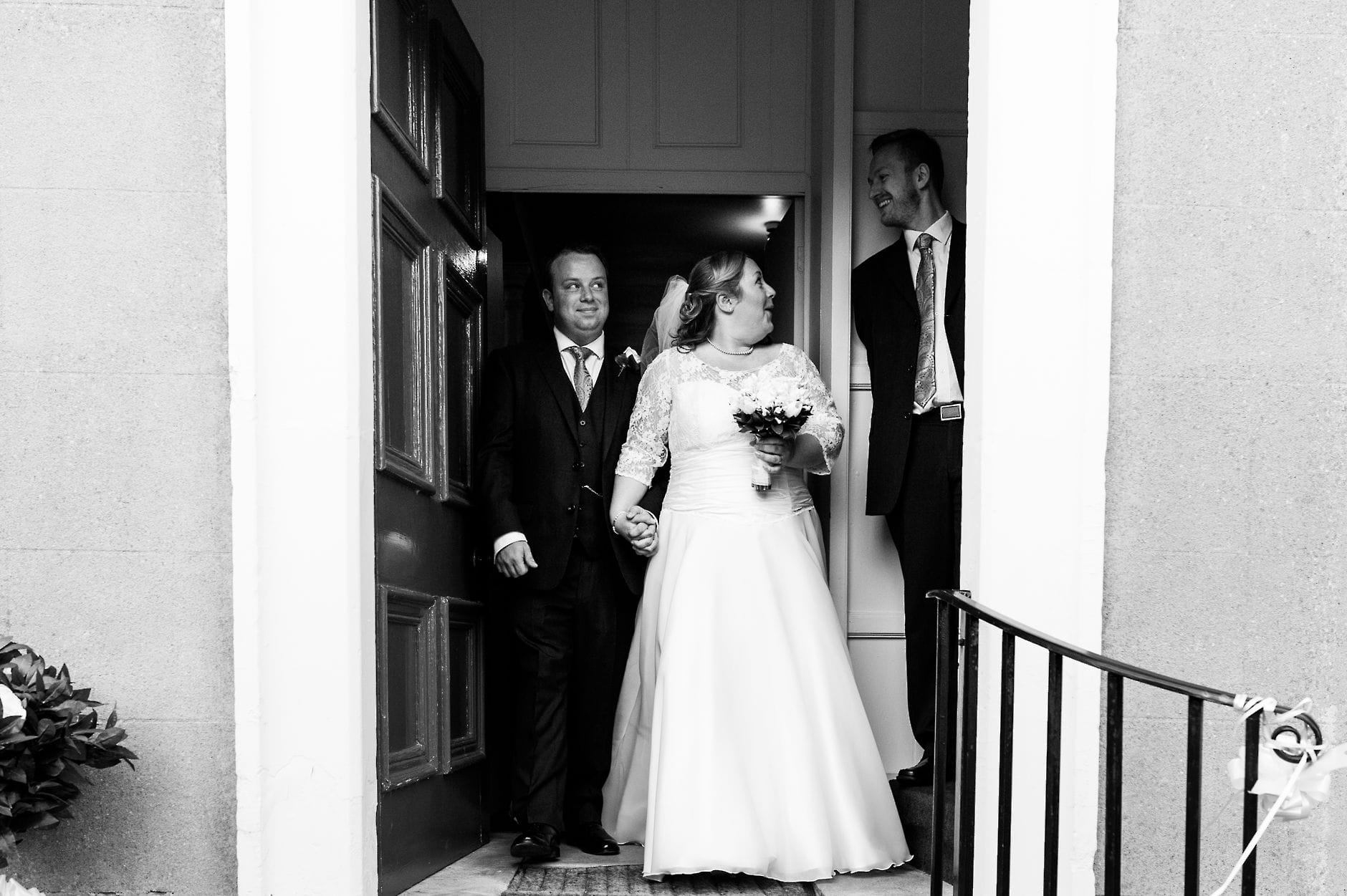 An English Village Wedding in Melbourne Derbyshire bride and groom surprised as they leave the church