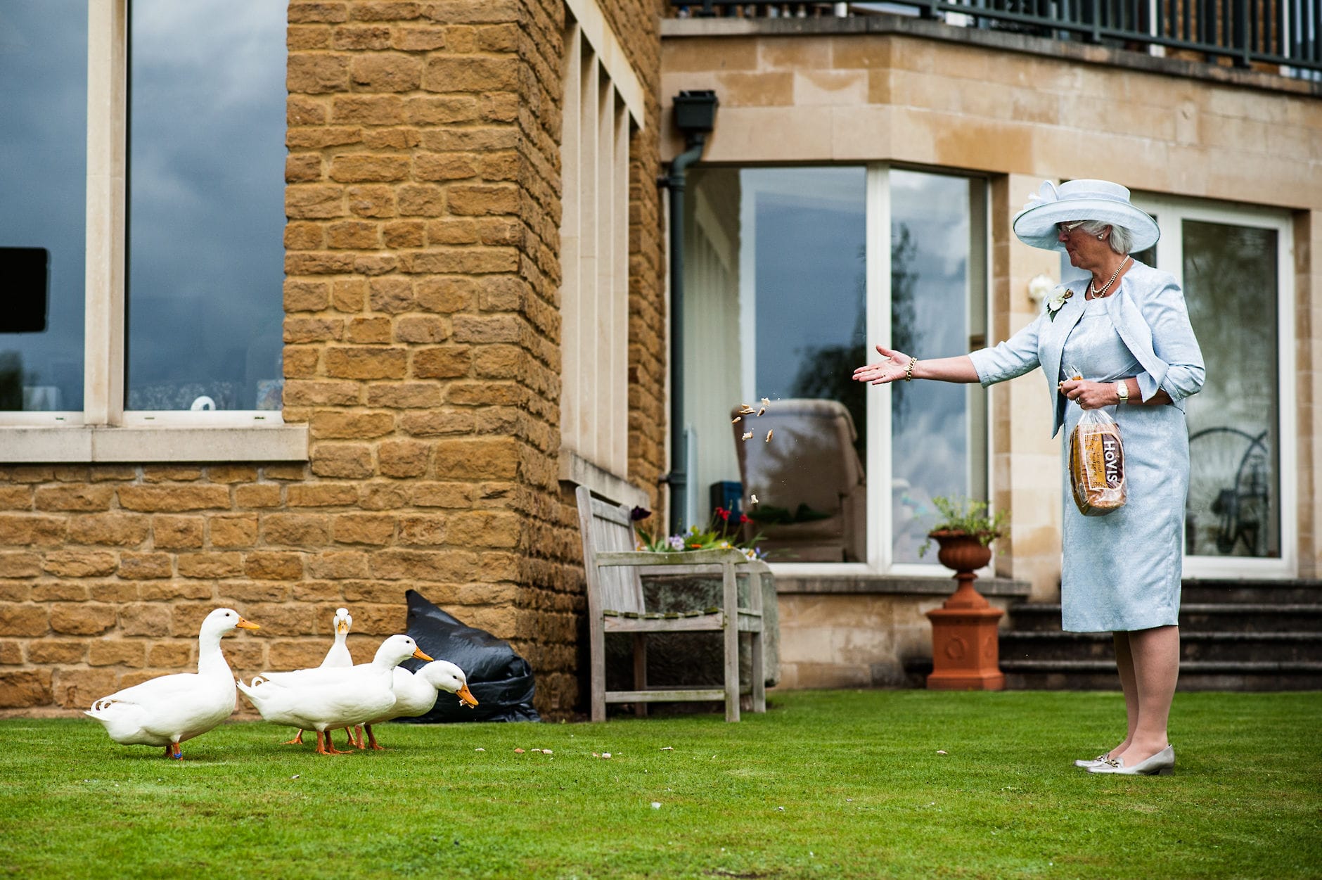 An English Village Wedding in Melbourne Derbyshire mother of the bride feeding ducks