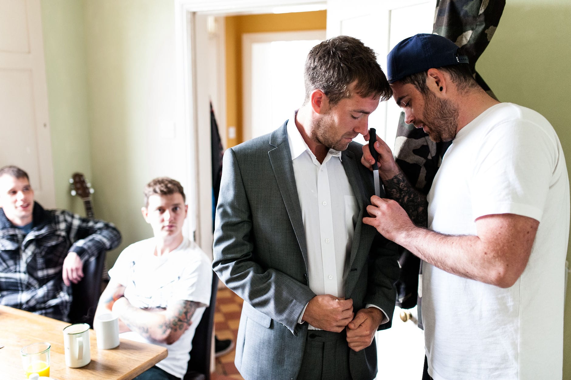 groom attaching button holes