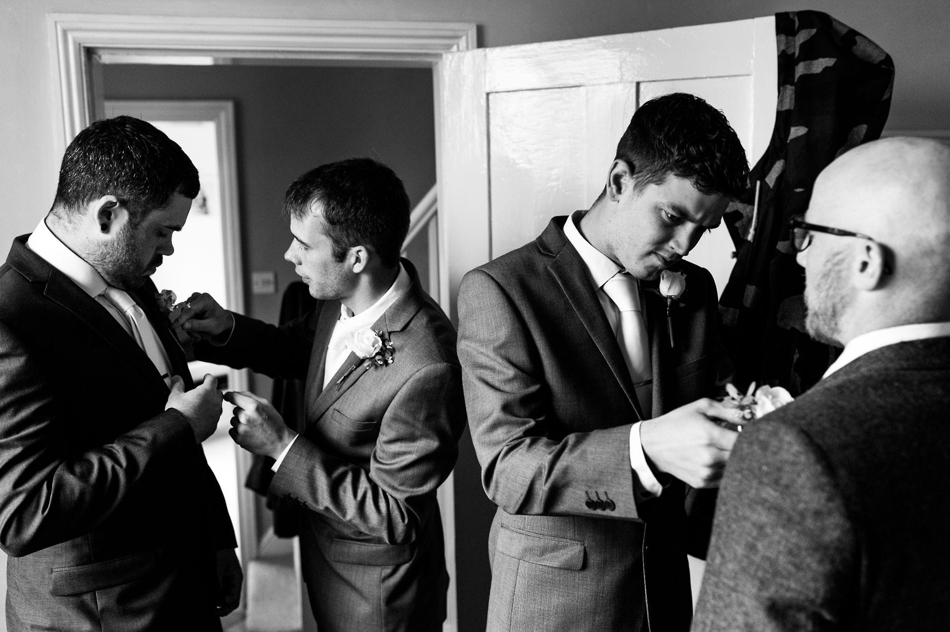 fitting flowers on groomsmen