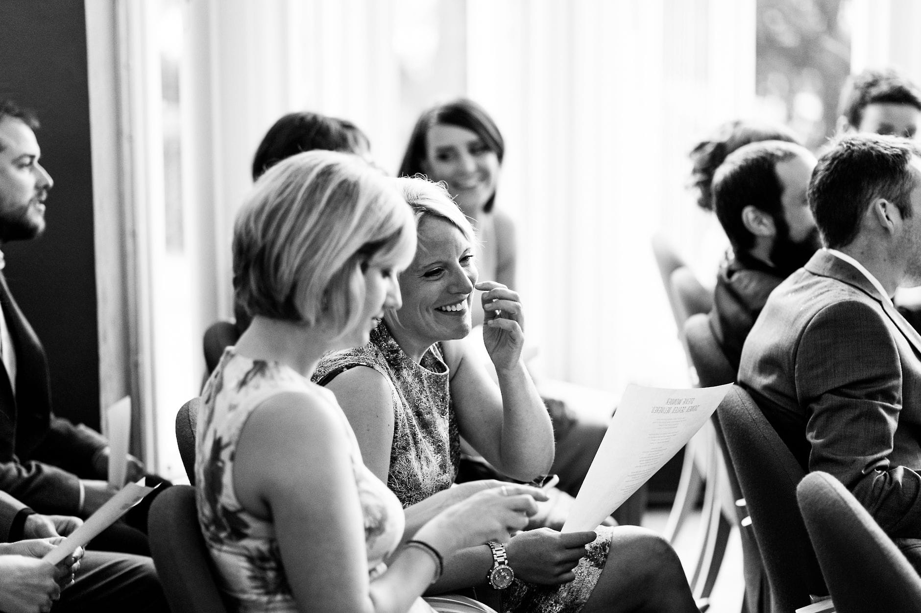 ladies laughing at wedding ceremony