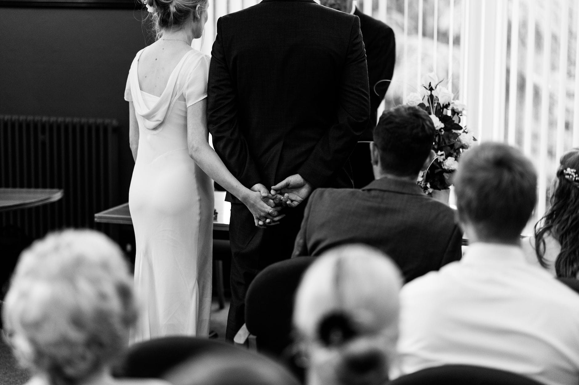 bride and groom holding hands during ceremony