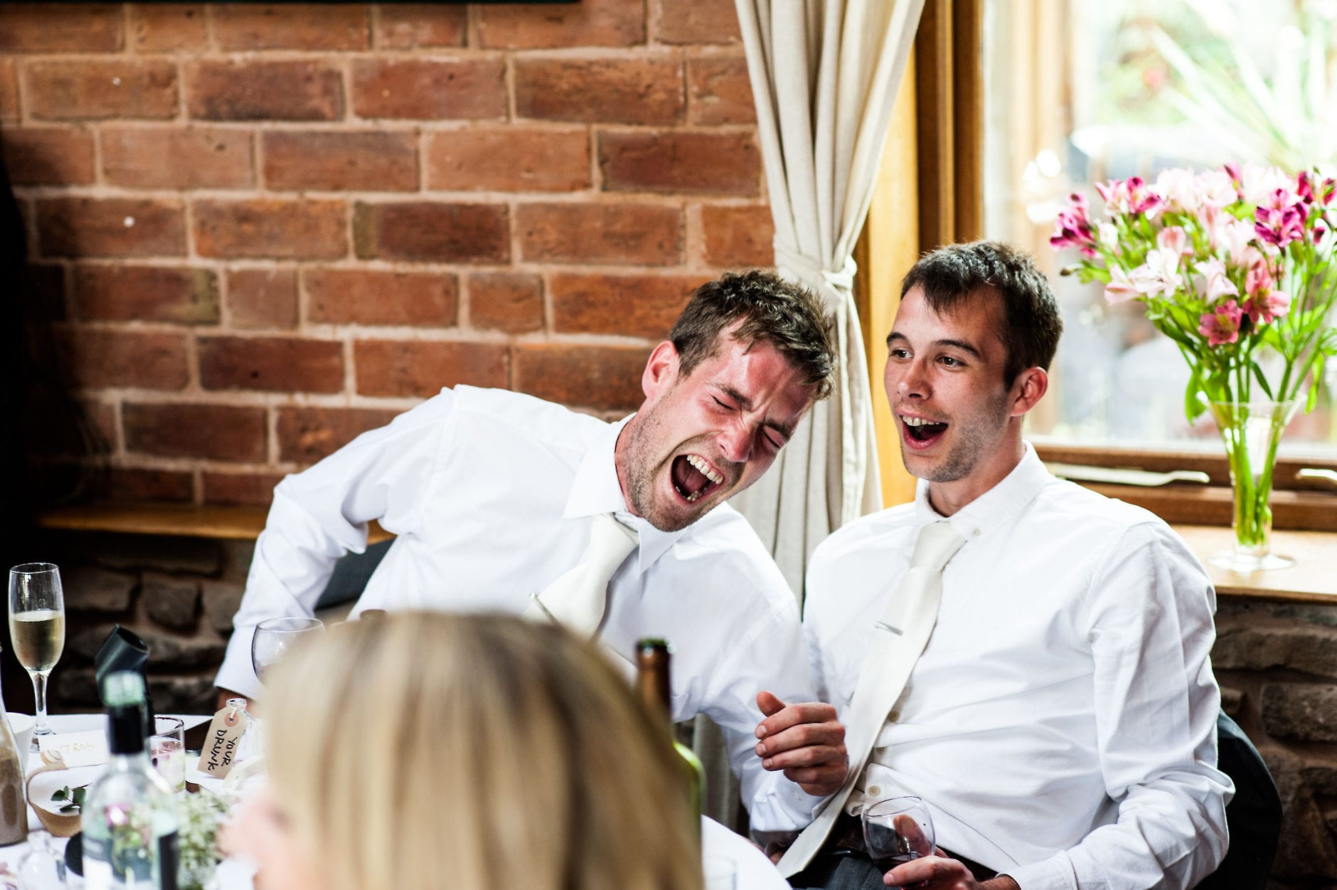 guests laughing during wedding speeches