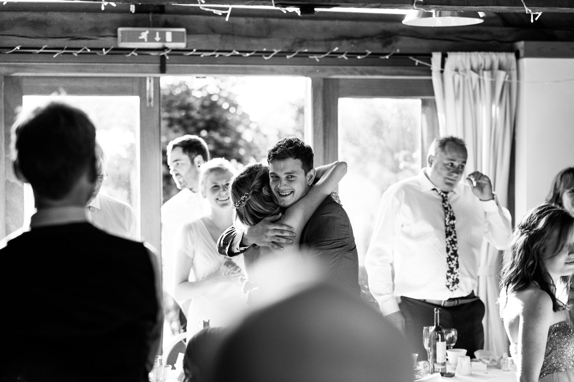 best man hugging bridesmaid