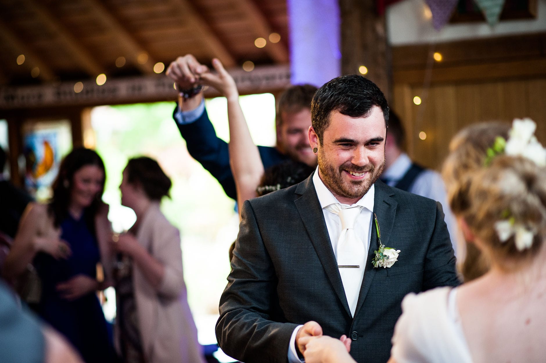 groom smiling at bride first dance