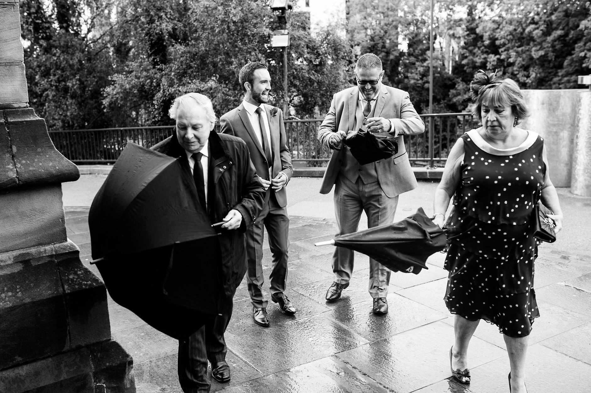 Wedding guests arriving at the church in the rain