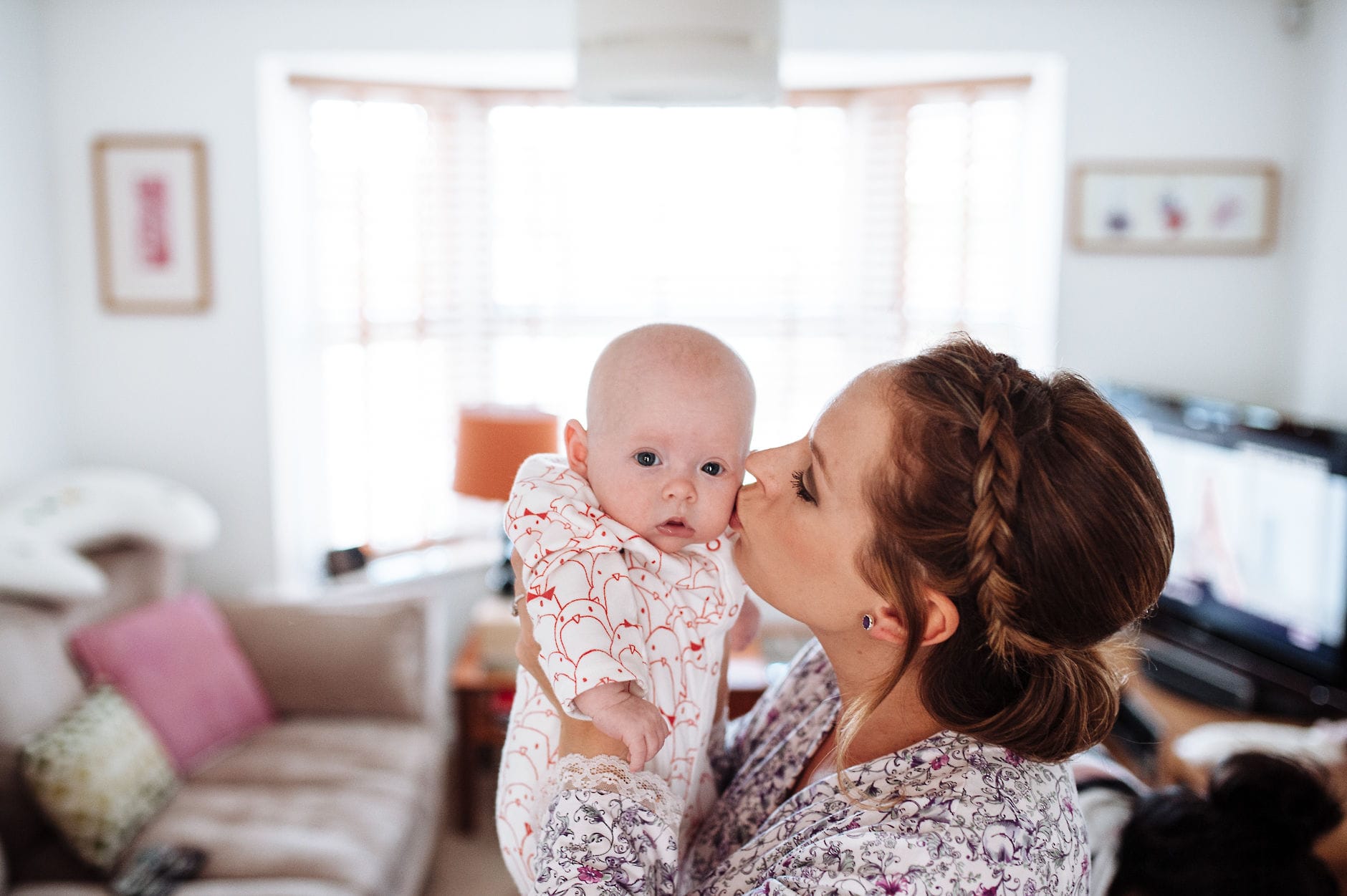 bride kissing a baby on the cheek