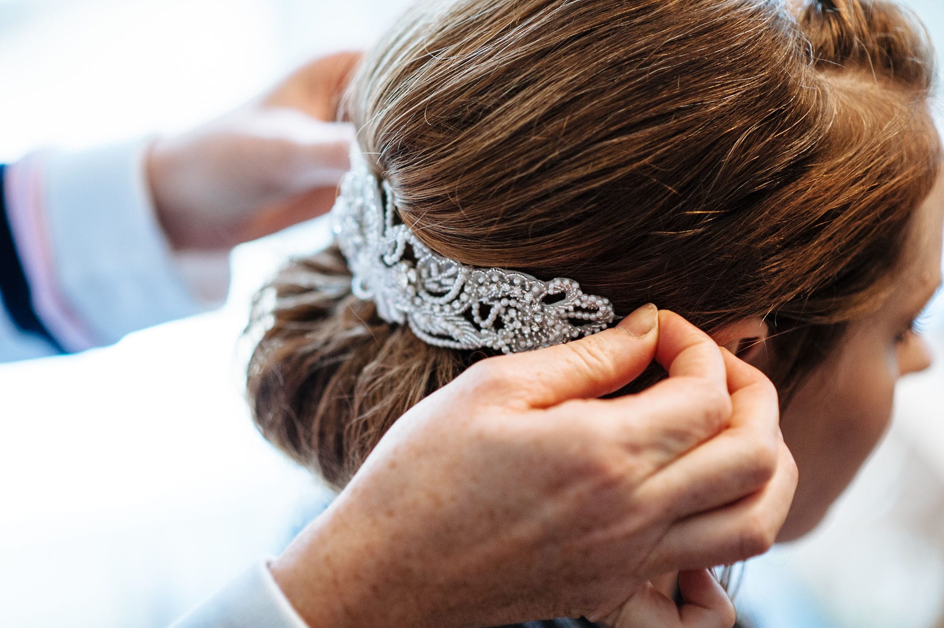 bride having hair barrette fitted