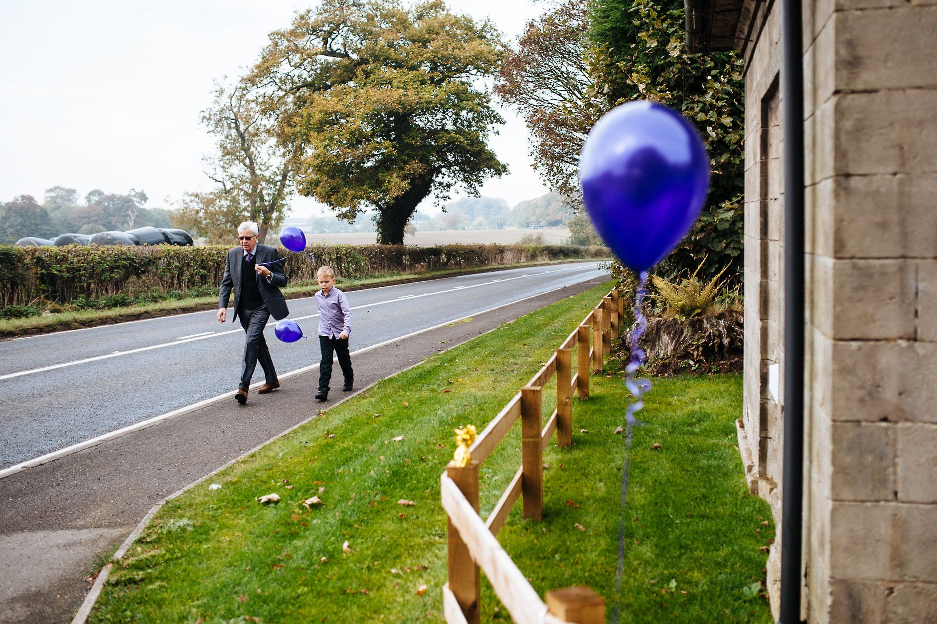 guests arriving at yeldersley hall holding purple balloons