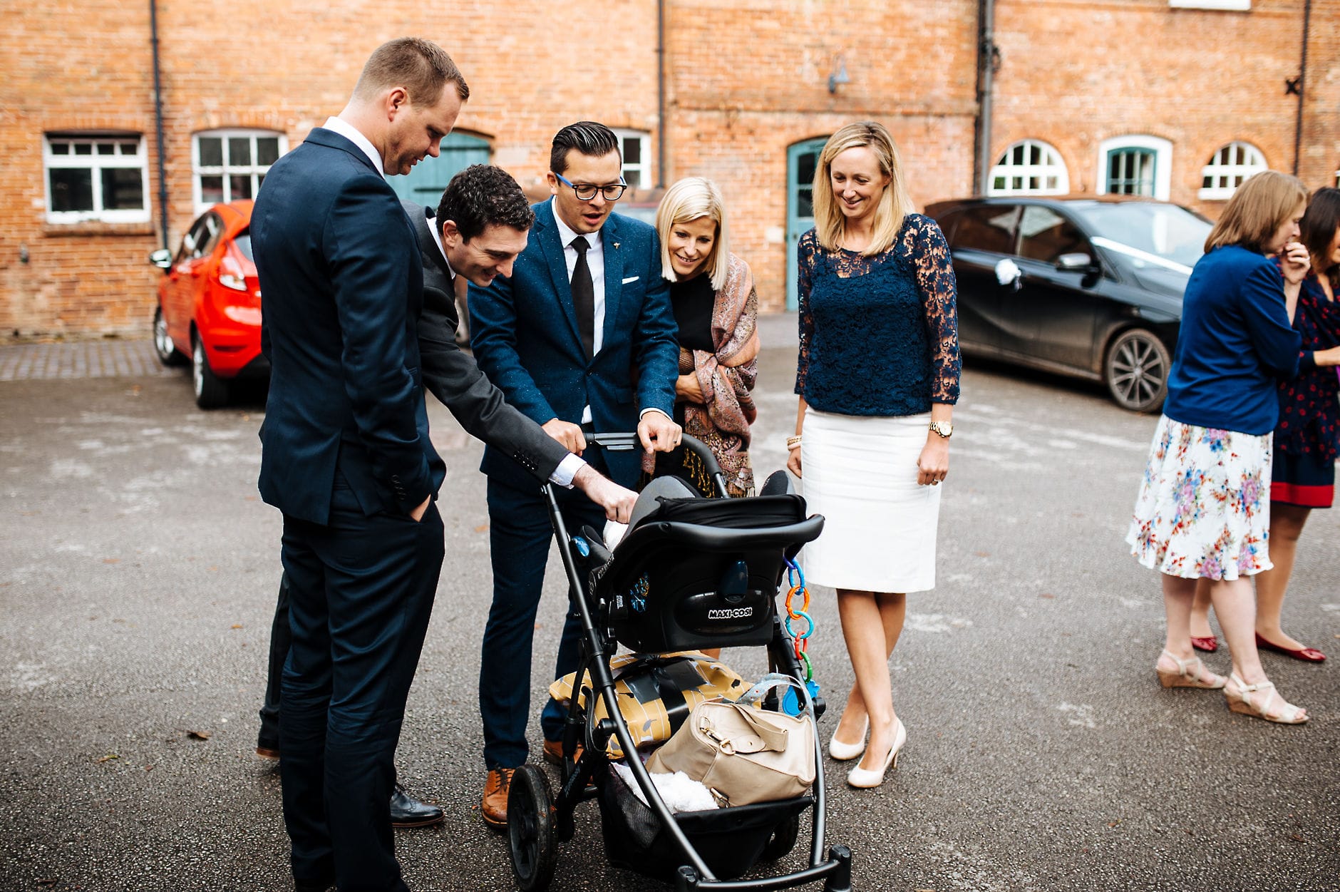 Wedding guests fussing over a baby
