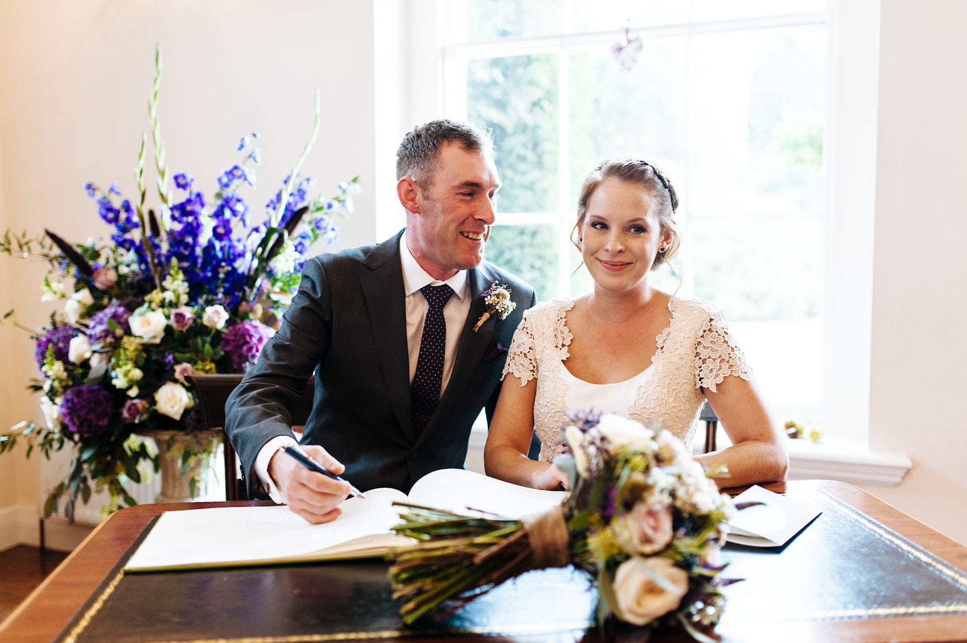 Bride and groom signing the register
