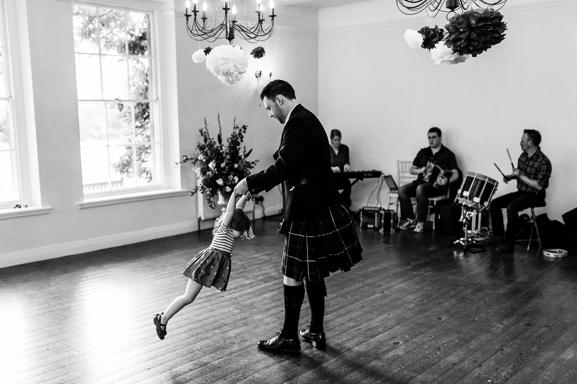 Child being swung around at a wedding