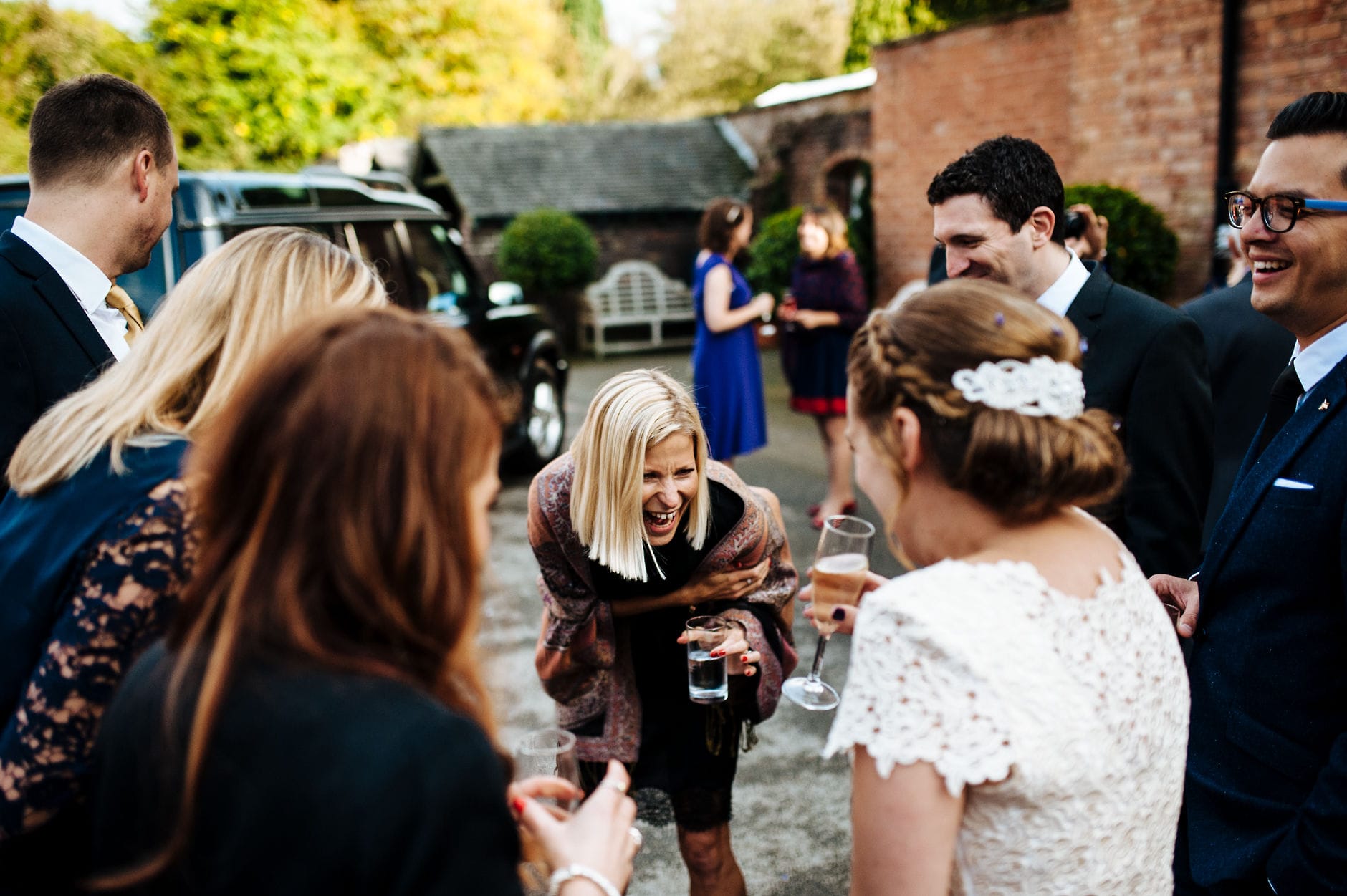 Laughing wedding guests