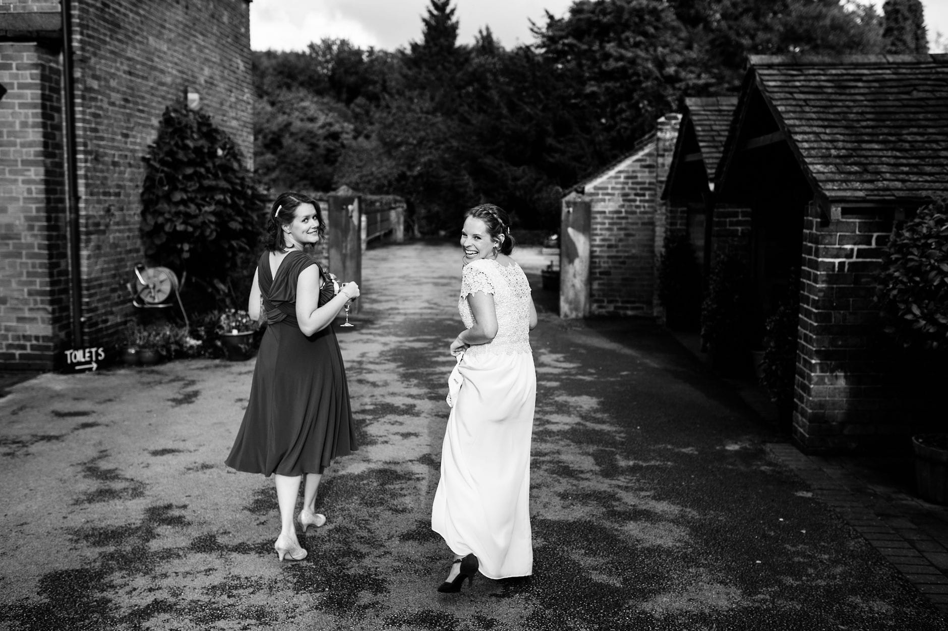 bride and bridesmaid walking through the venue grounds