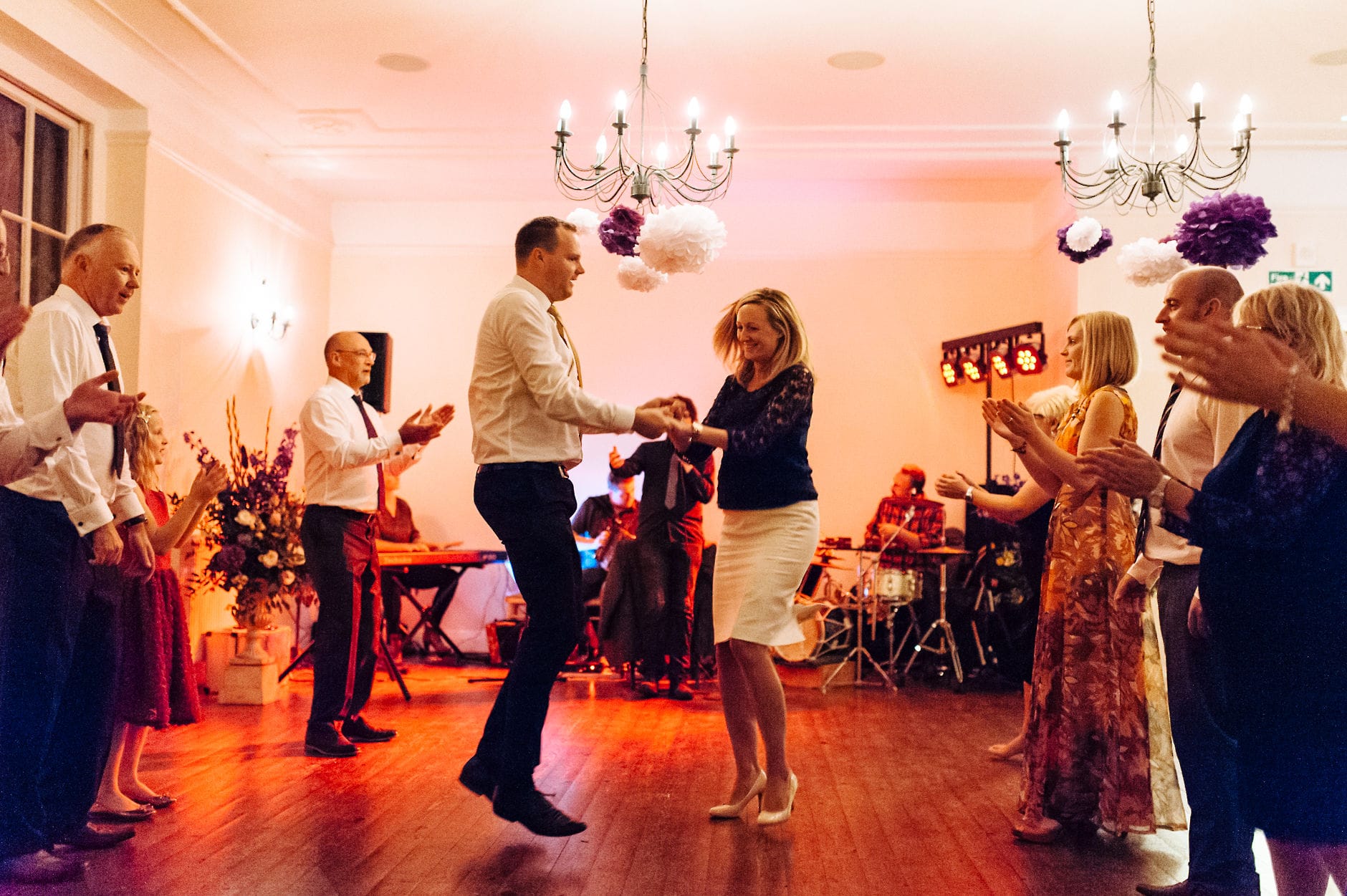 Wedding guests dancing ceilidh