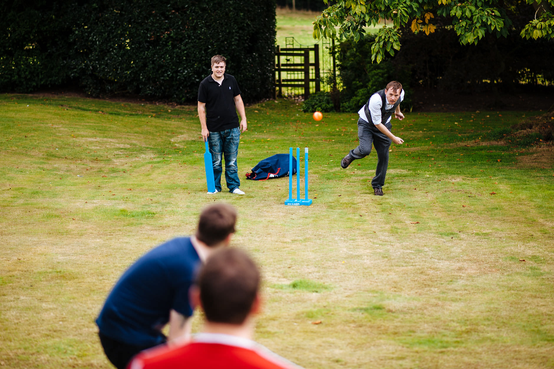 groom playing cricket with guests