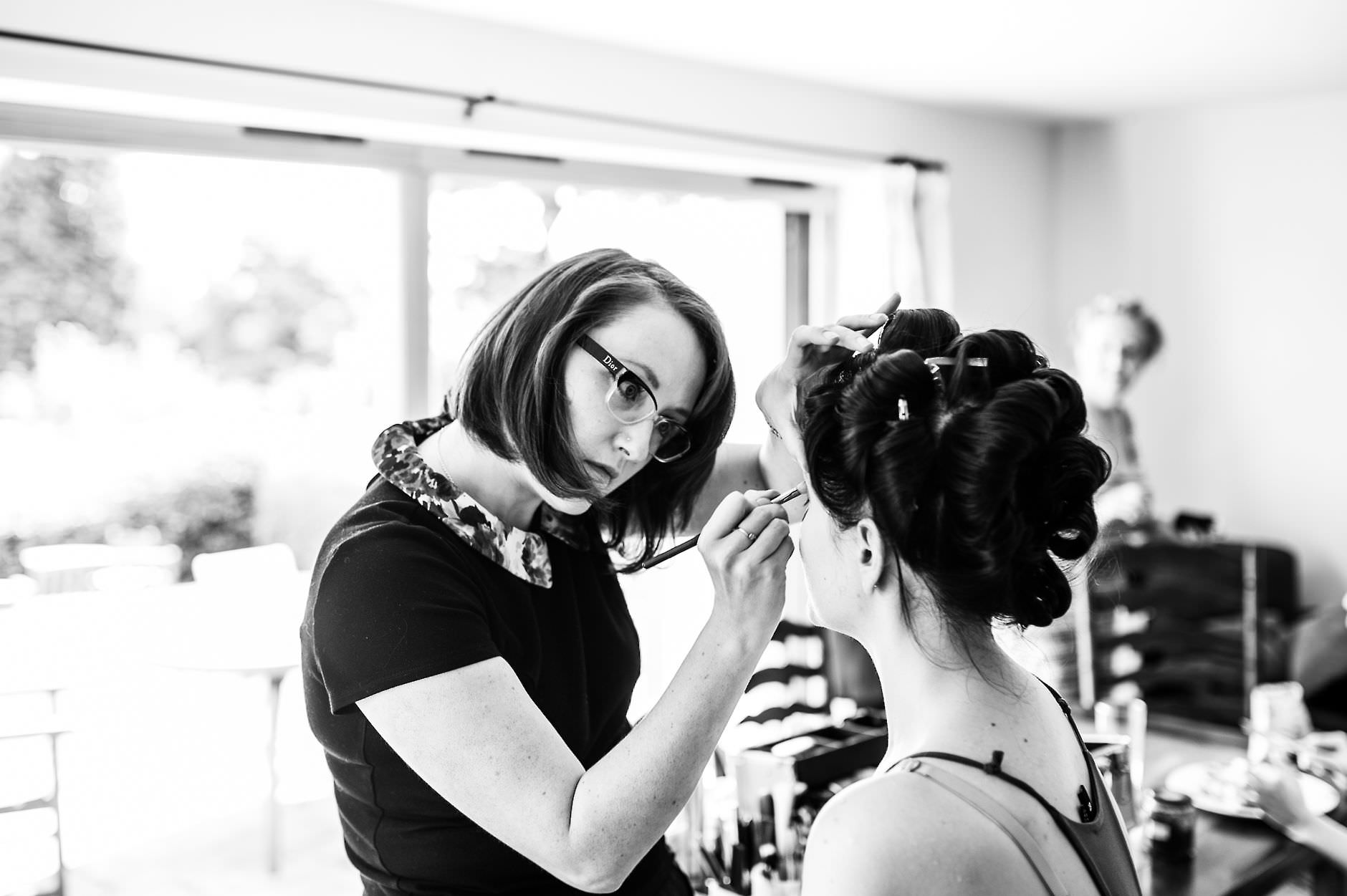 make-up artist working on the bride