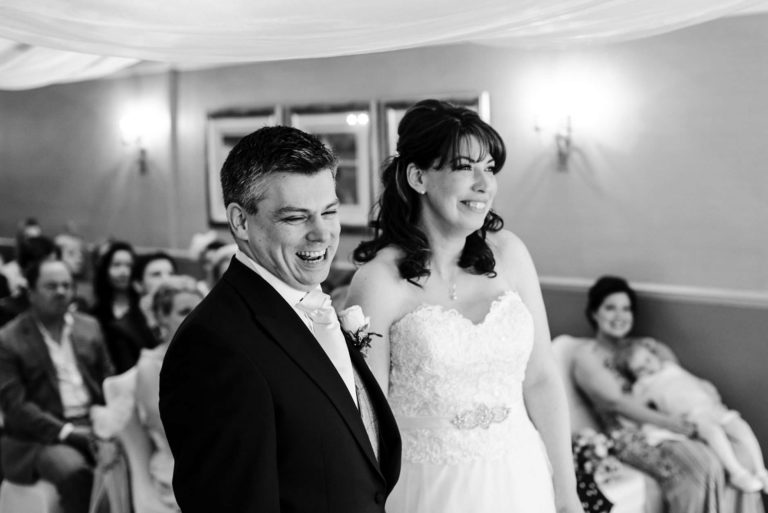 groom laughing during ceremony
