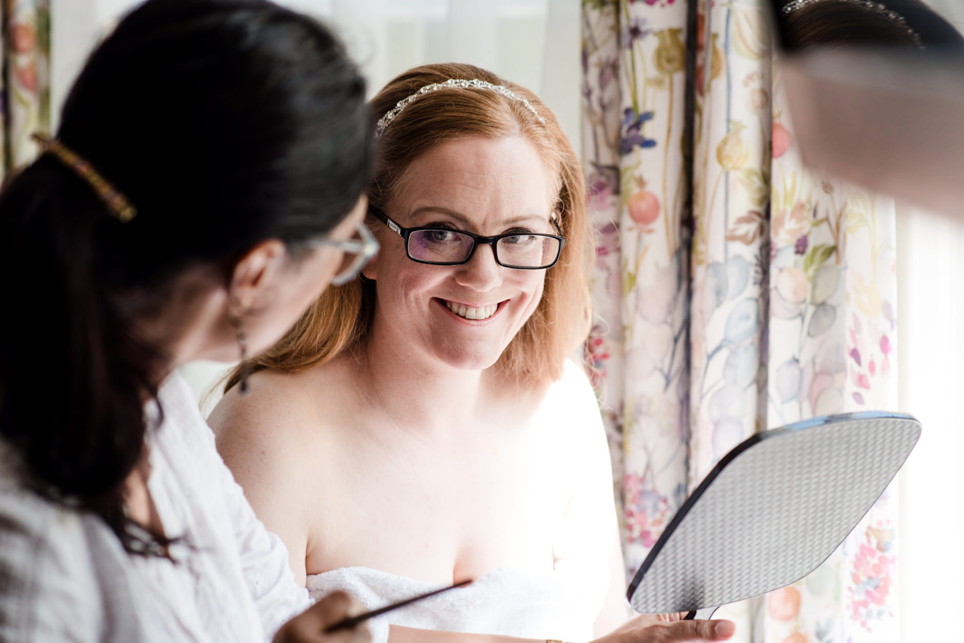 bride smiling at her make up artist