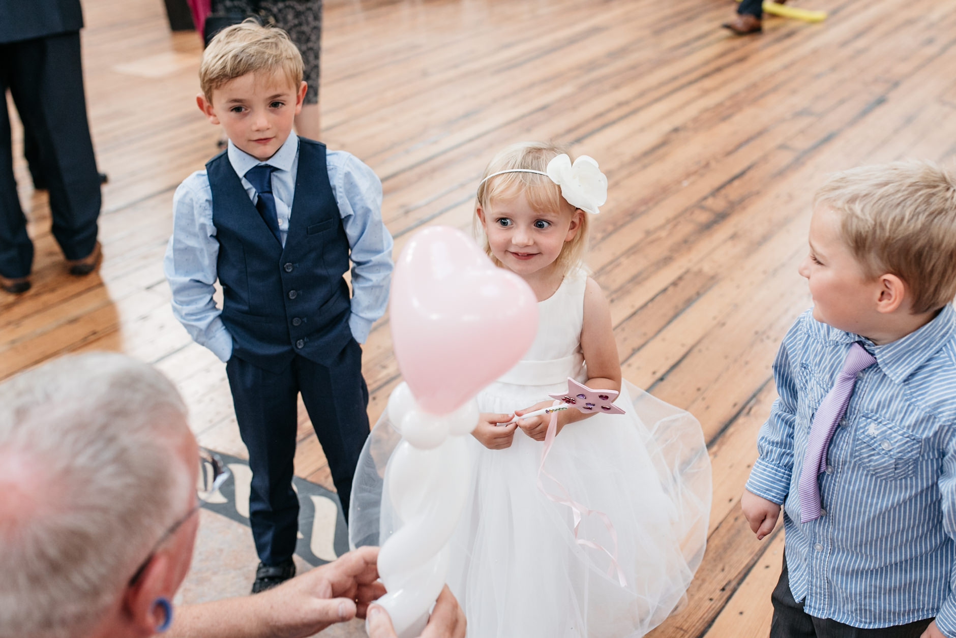 balloon man makes heart balloon for little girl