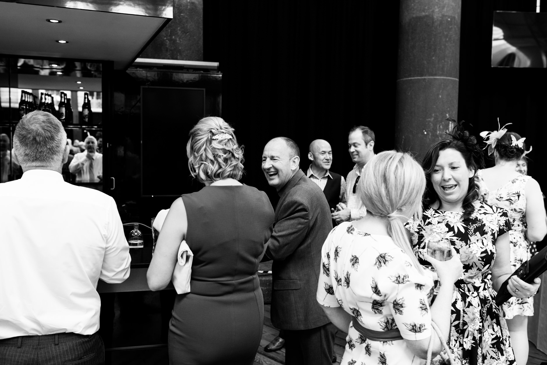 guests chatting at the bar