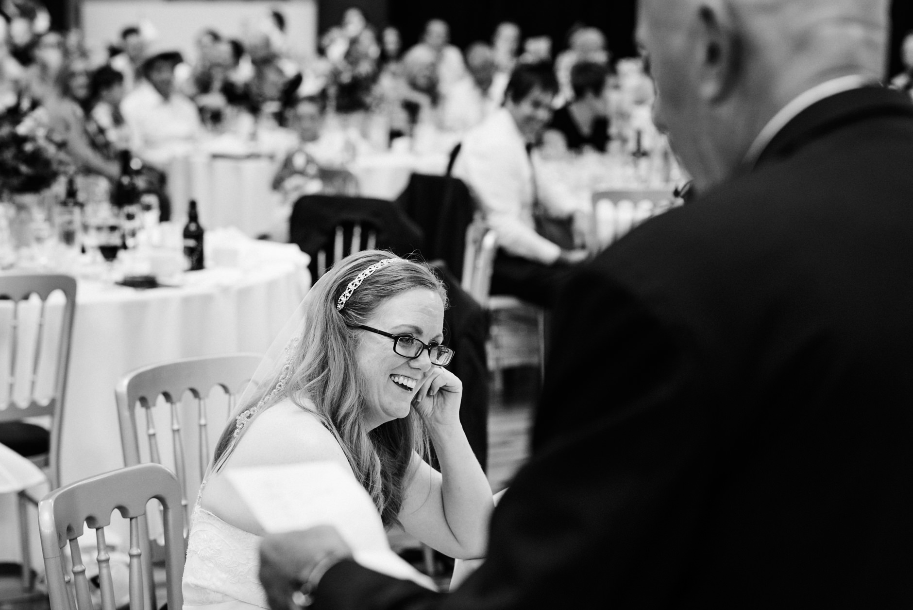 bride laughing during her father's speech