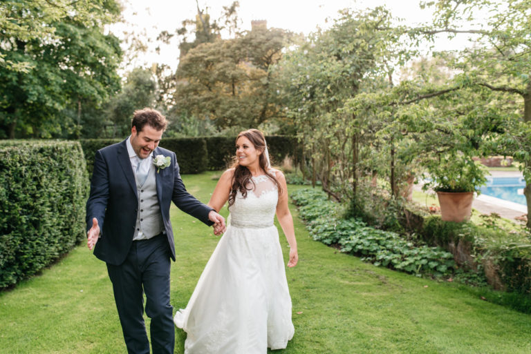 skipwith hall wedding photo of a bride and groom walking around the grounds