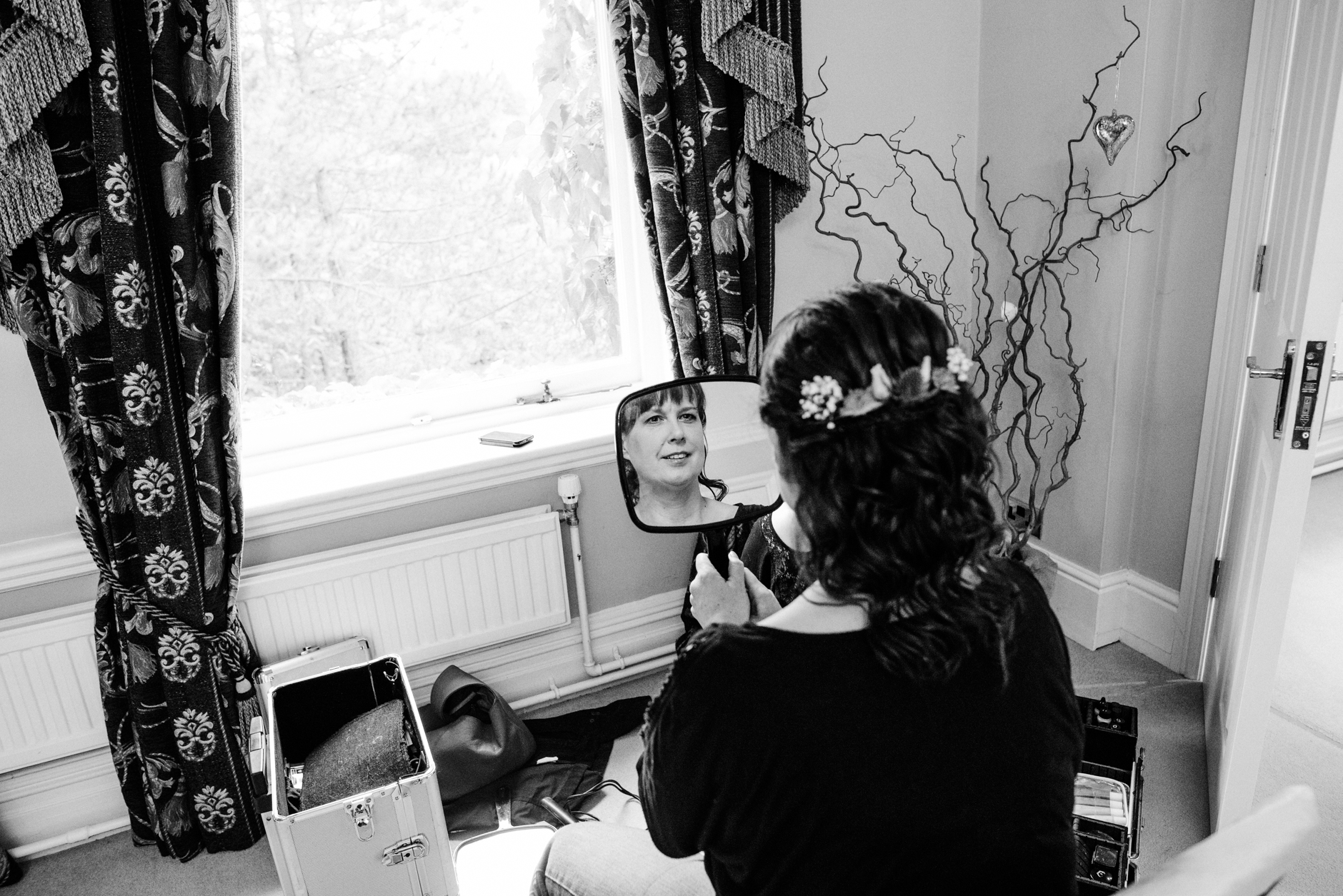 bride looking in a hand mirror