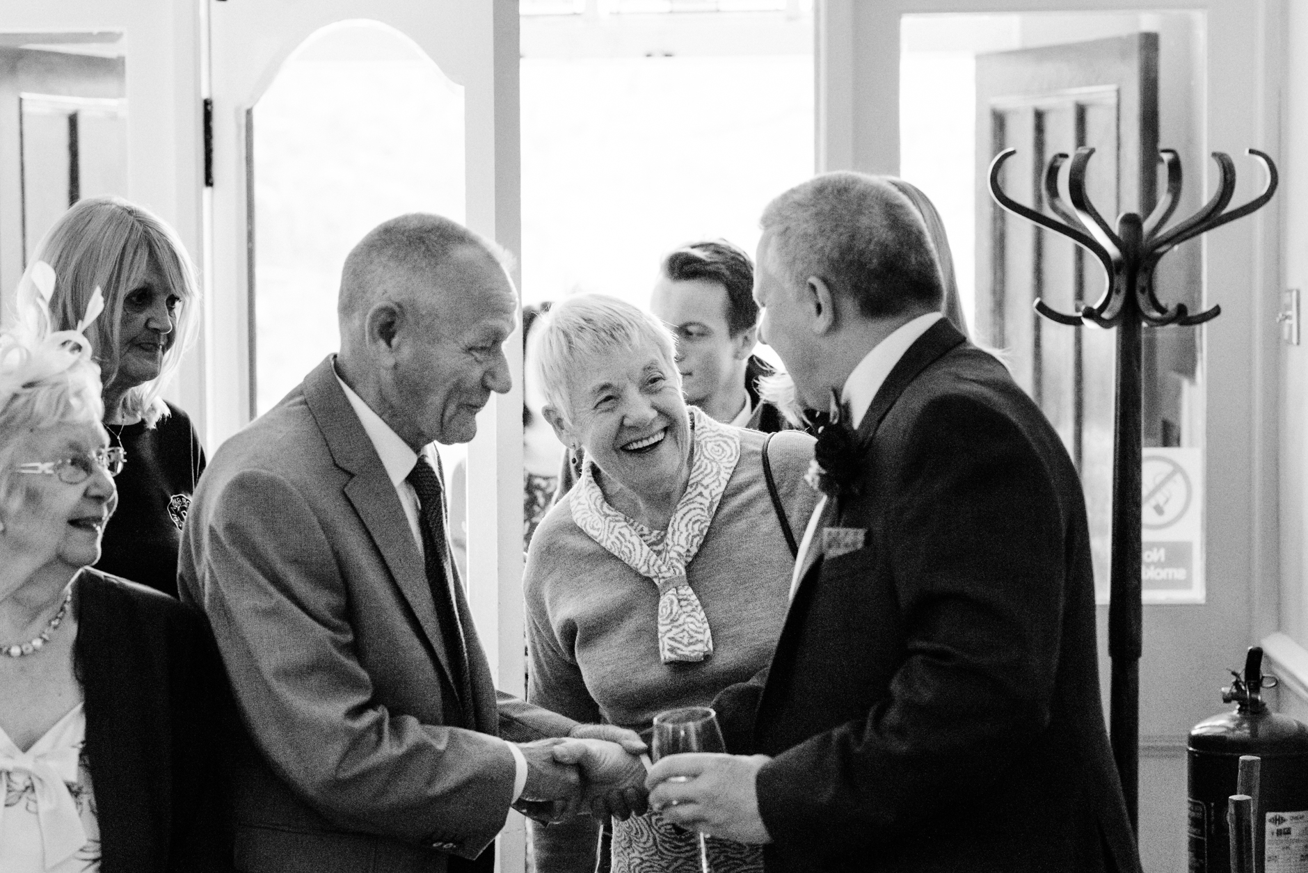 groom greeting guests in the lobby