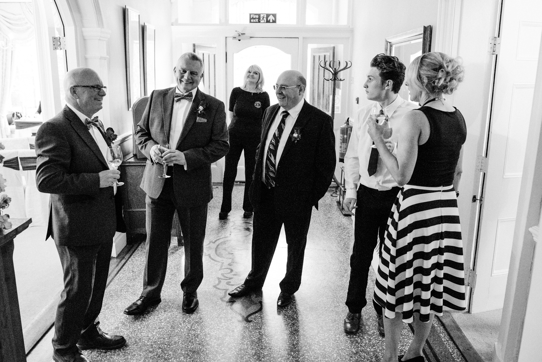 guests gathering around the groom before the ceremony