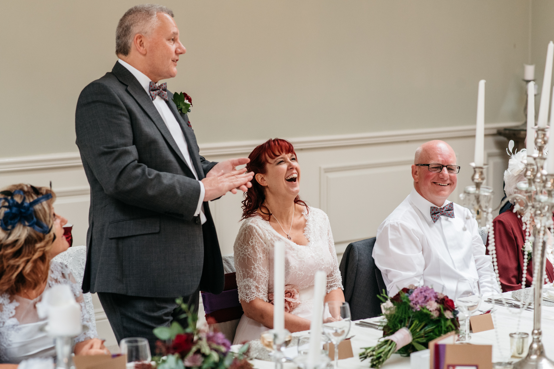 bride laughing during grooms speech