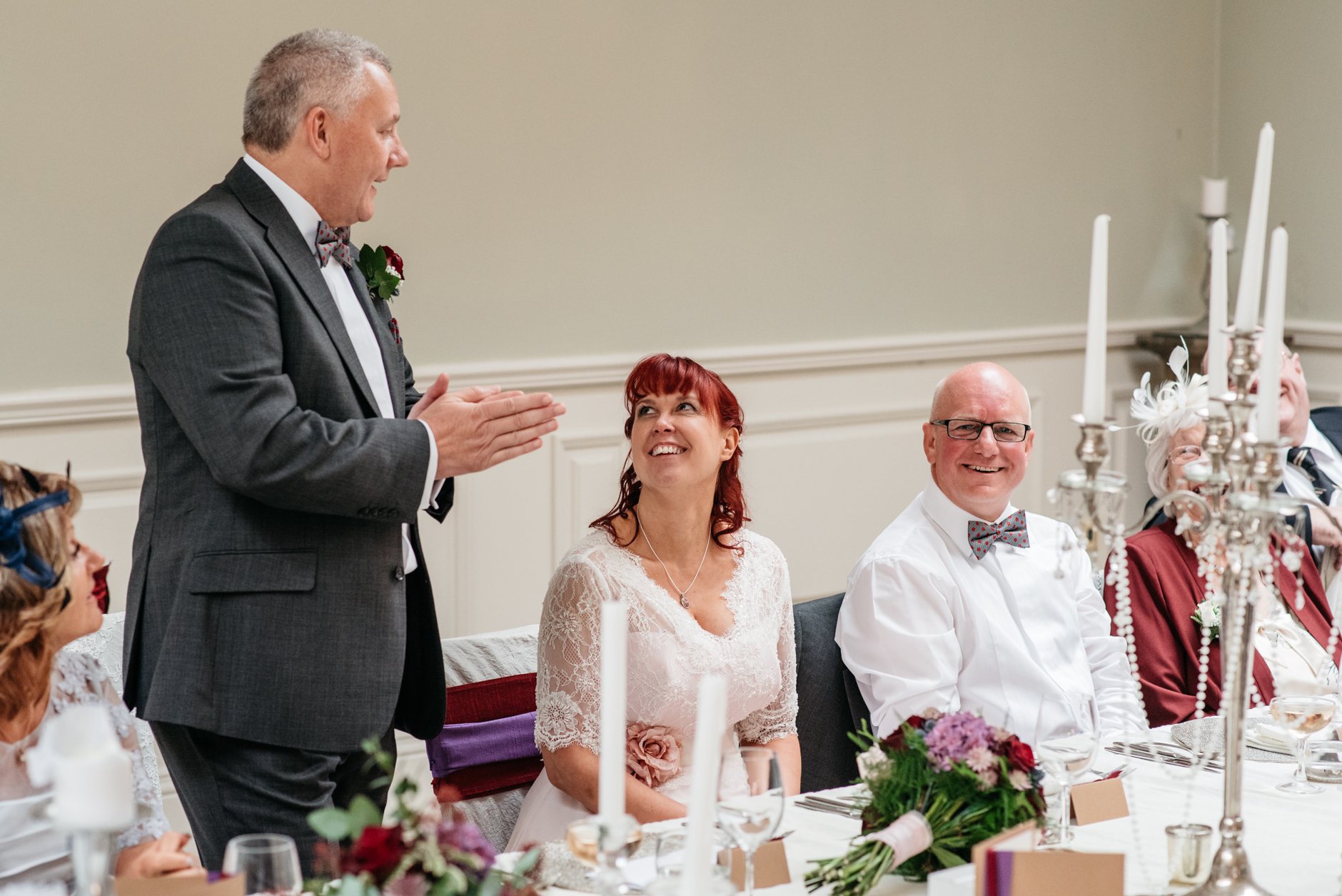 bride and groom look at each other lovingly during speeches