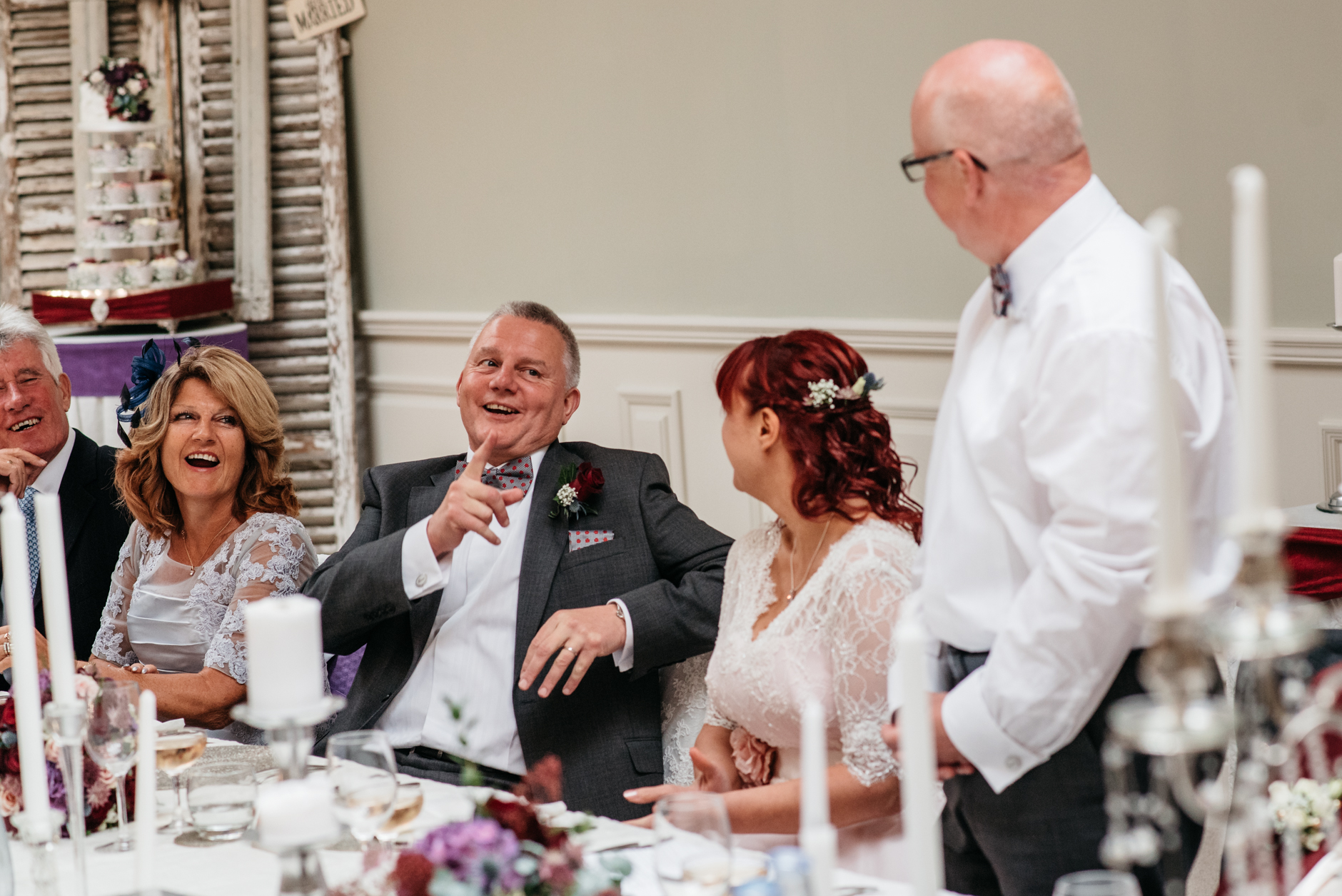 groom laughing during best man's speech