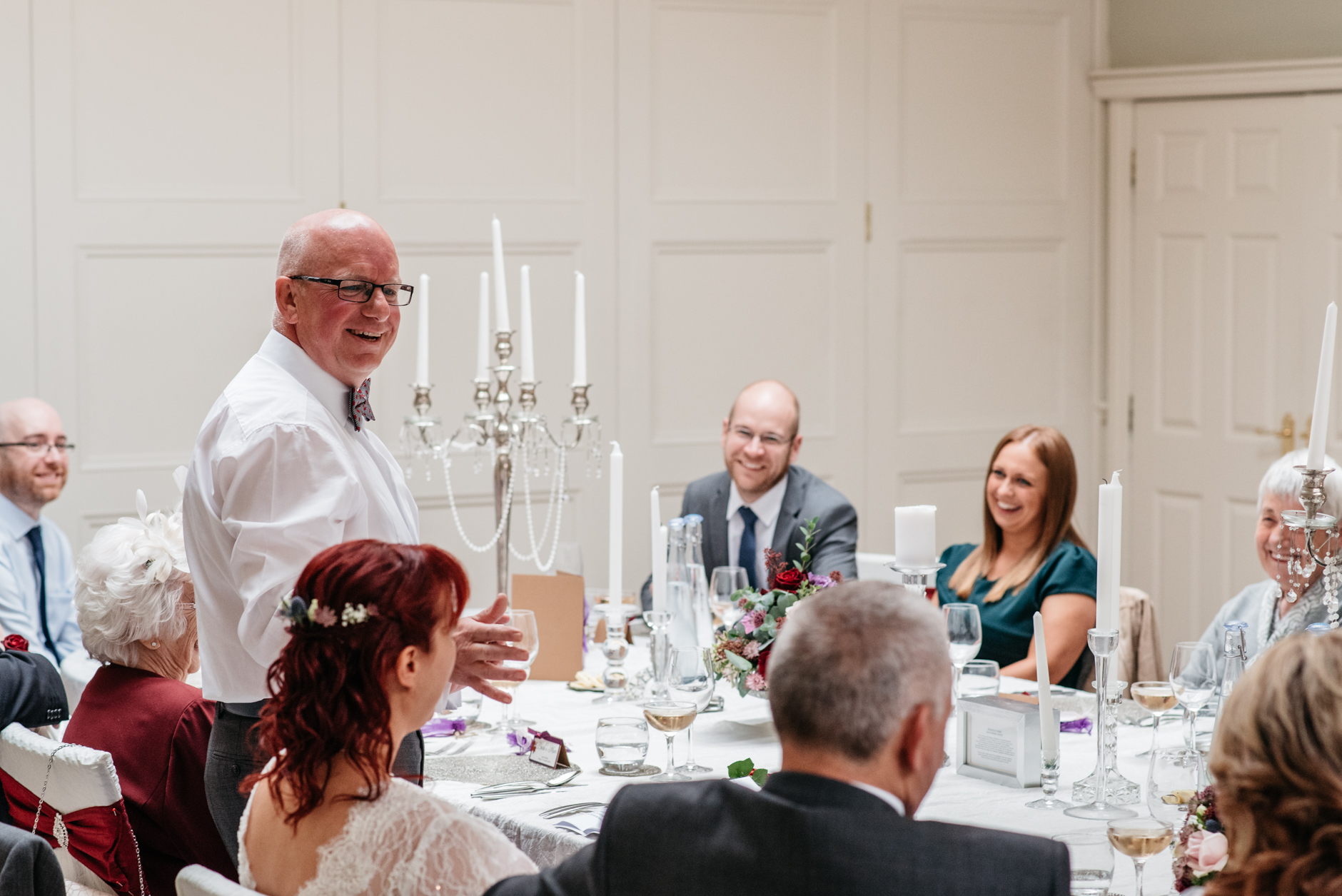 smiling guests during best man's speech