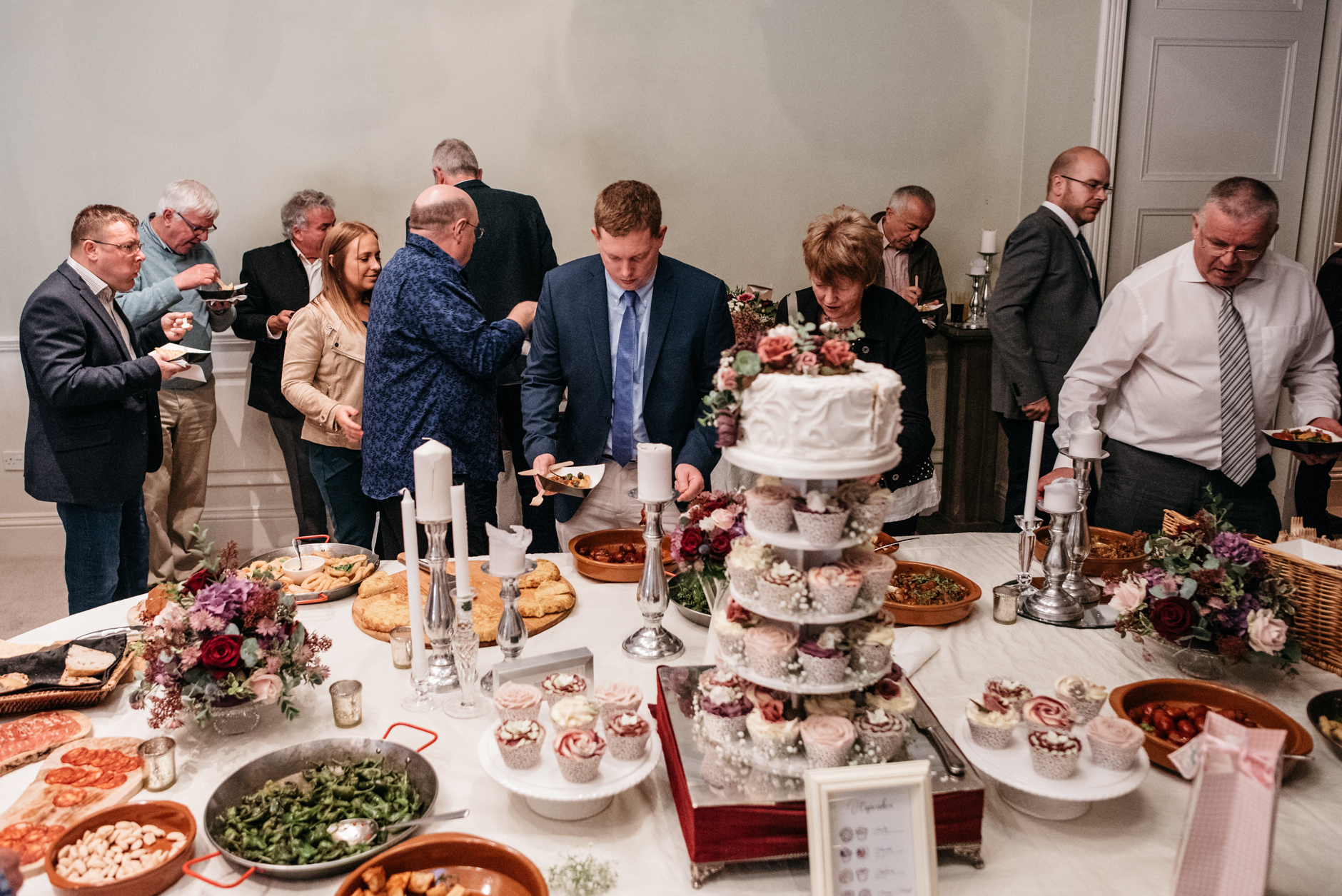 wedding cake surrounded by evening buffet