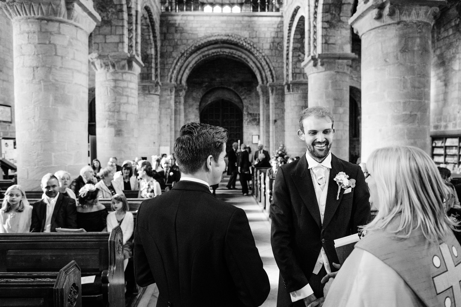 Groom with a big smile at the altar