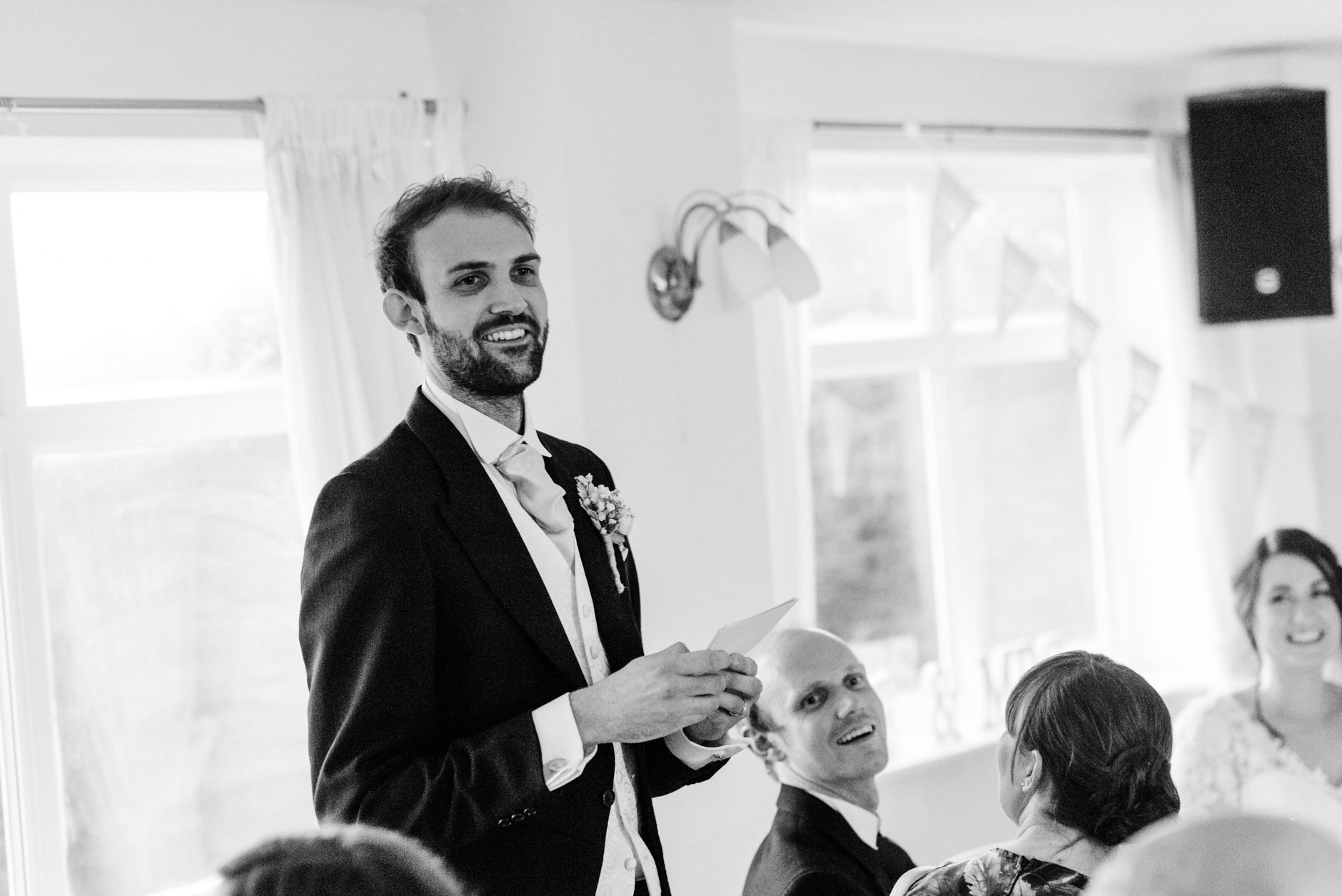 Smiling groom giving his speech