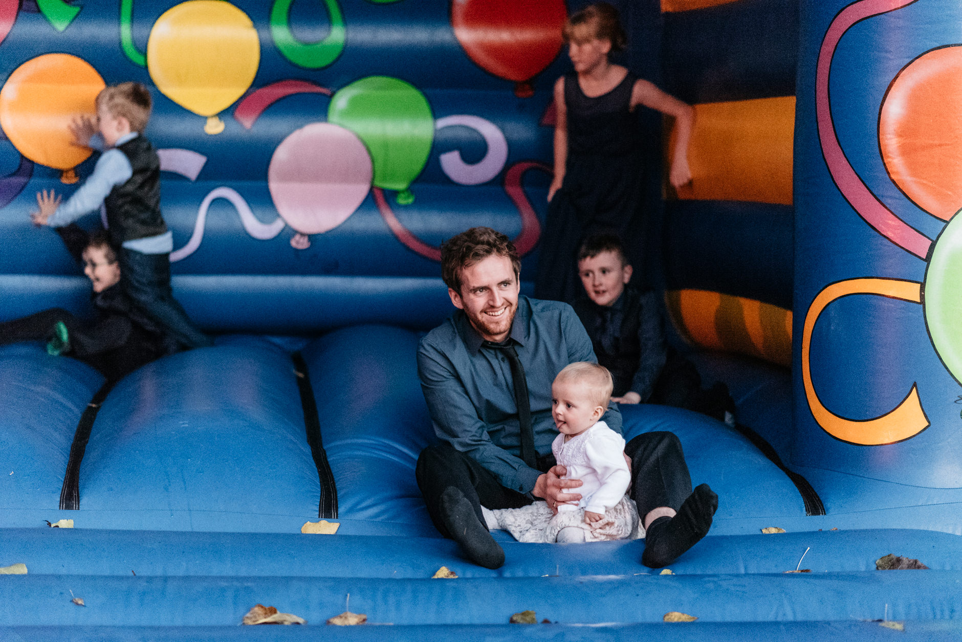 A guest on the bouncy castle with his child