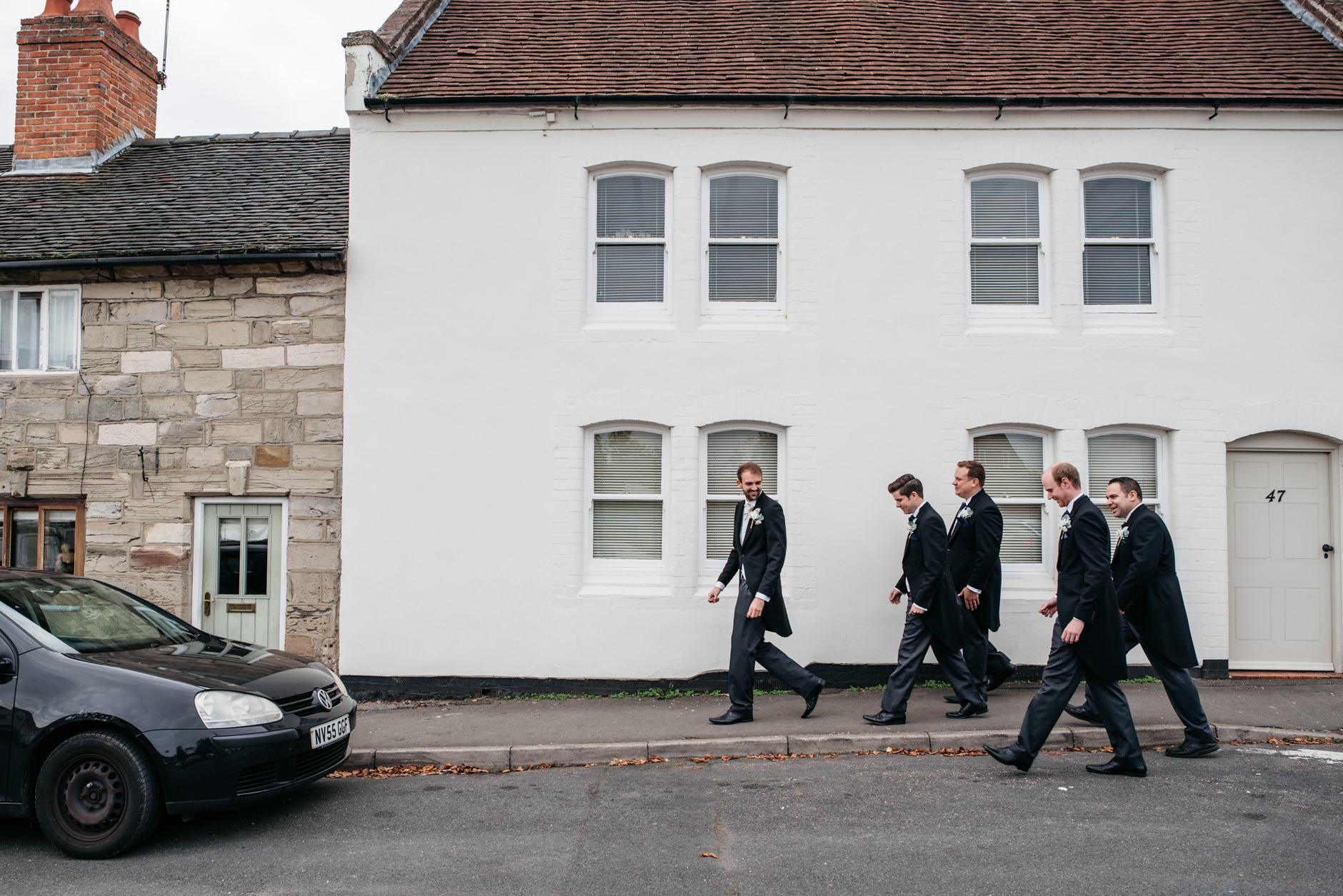 Groom and groomsmen walking to the church