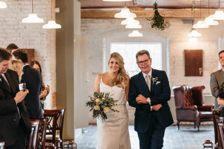 bride walking down the aisle with her dad