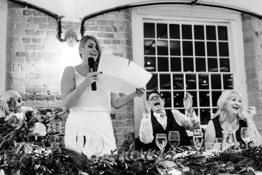 bride's father laughing during her speech