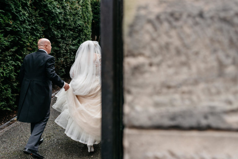 father of the bride holding the dress