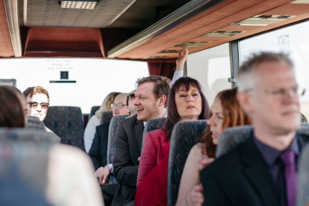 guests on a coach to wedding venue