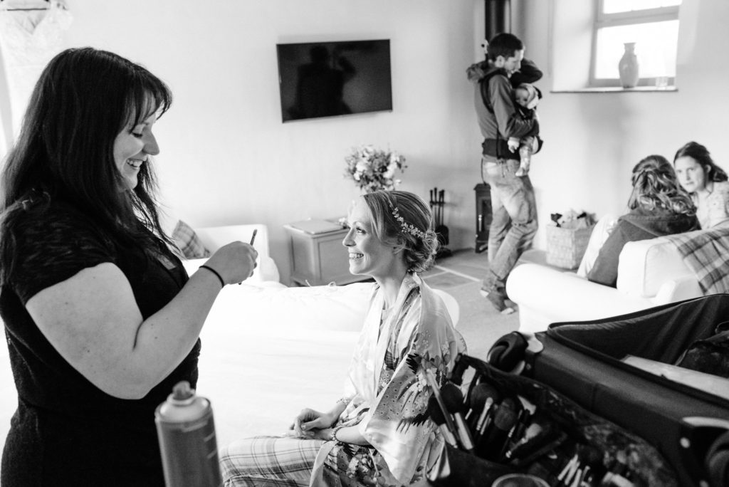 bride laughing with make-up artist