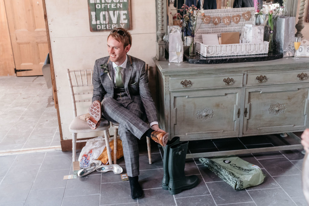 groom putting on wellies