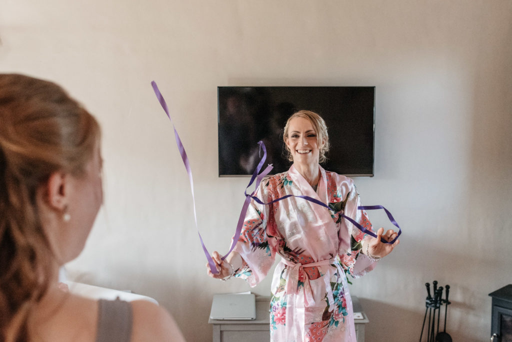 bride twirling the belt of her gown