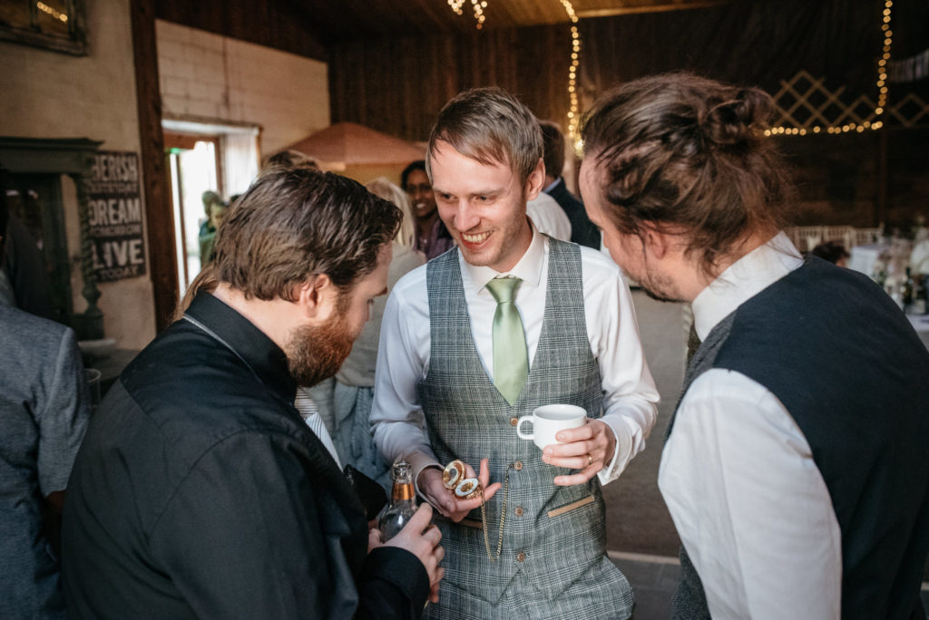 groom showing off his pocket watch