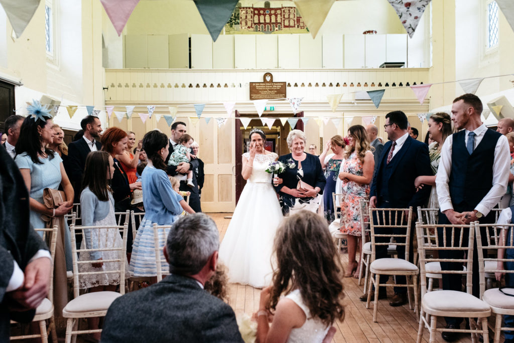 bride walking down the aisle at sir john moore school